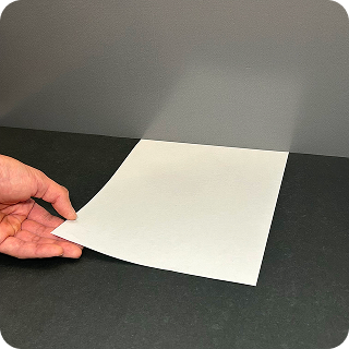 A sheet of printer paper laid flat on the floor